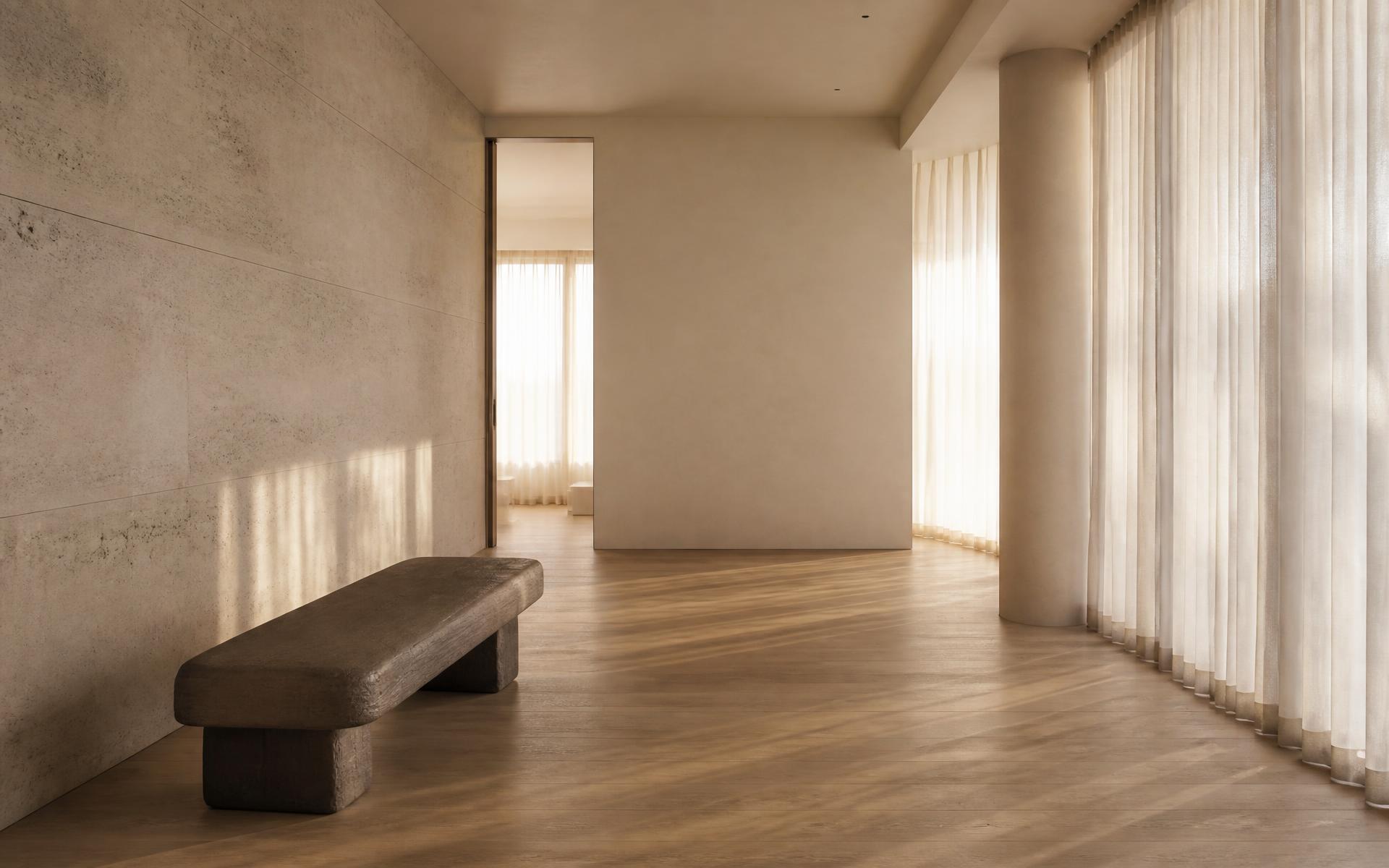 Minimal travertine and oak interior filled with soft natural light